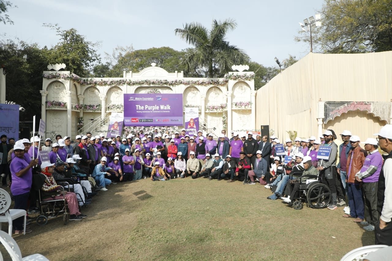 Large group of participants gathered for The Purple Walk dementia awareness event